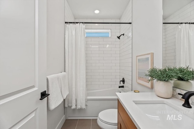 full bathroom featuring tile patterned floors, vanity, toilet, and shower / tub combo