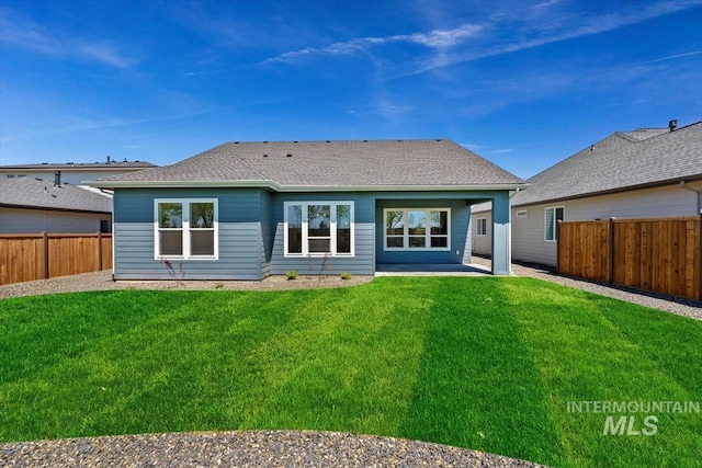 rear view of house featuring a lawn