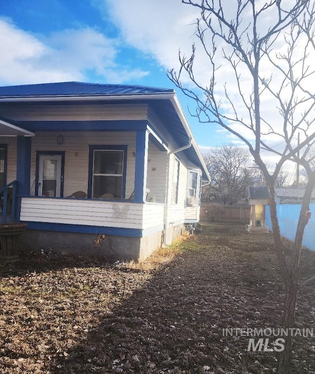 view of property exterior featuring covered porch