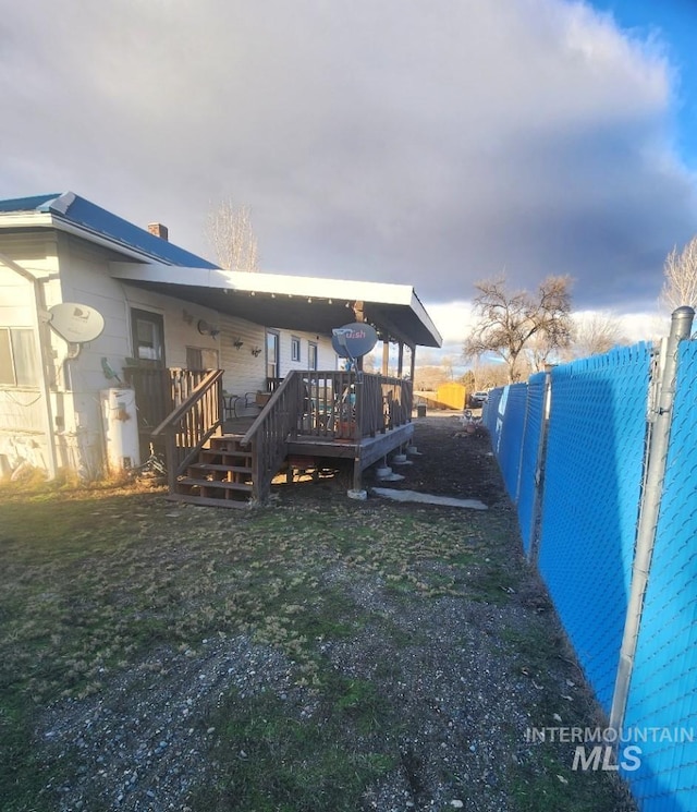 exterior space featuring a yard and a wooden deck