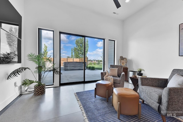 6553 S Pemberley Way, Meridian, ID 83642 - living area with a towering ceiling, a ceiling fan, and baseboards