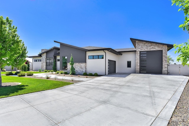 6553 S Pemberley Way, Meridian, ID 83642 - contemporary house with stone siding, a garage, and driveway