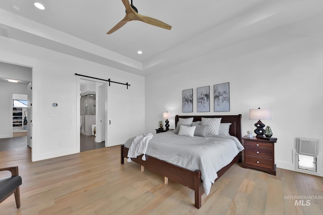 6553 S Pemberley Way, Meridian, ID 83642 - bedroom featuring a barn door, wood finished floors, recessed lighting, baseboards, and ceiling fan
