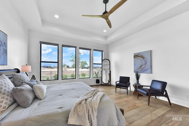 6553 S Pemberley Way, Meridian, ID 83642 - bedroom featuring light wood-style floors, recessed lighting, a tray ceiling, baseboards, and ceiling fan