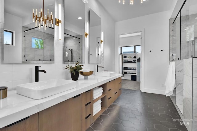 6553 S Pemberley Way, Meridian, ID 83642 - bathroom with a shower stall, double vanity, tile patterned flooring, recessed lighting, and a spacious closet