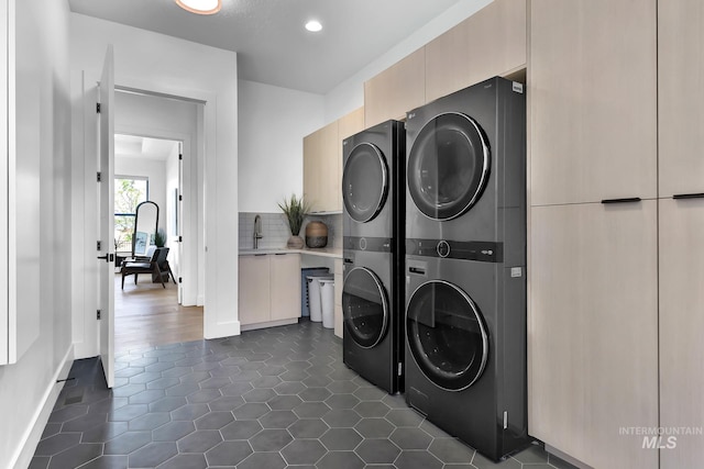 6553 S Pemberley Way, Meridian, ID 83642 - laundry area featuring stacked washer / drying machine, baseboards, dark tile patterned flooring, and recessed lighting