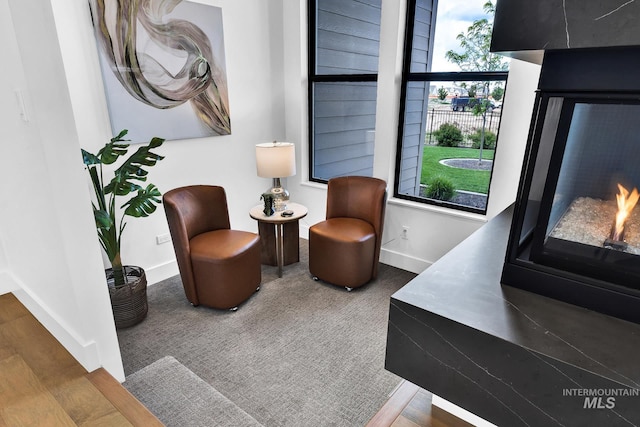 6553 S Pemberley Way, Meridian, ID 83642 - living area with baseboards, a warm lit fireplace, and wood finished floors