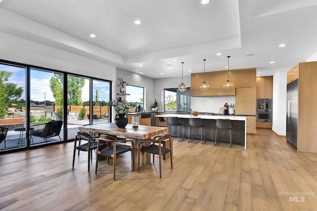 6553 S Pemberley Way, Meridian, ID 83642 - dining area with a raised ceiling, recessed lighting, and light wood-type flooring