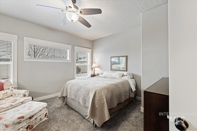 carpeted bedroom with multiple windows, ceiling fan, and a textured ceiling