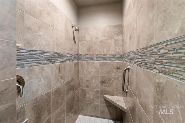 bathroom with a tile shower