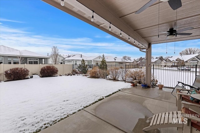 snow covered patio featuring ceiling fan