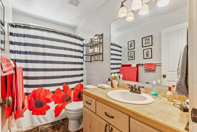 bathroom with curtained shower, vanity, a textured ceiling, and toilet