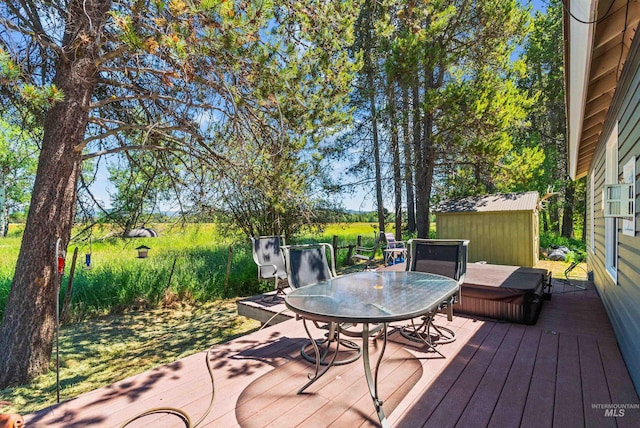 deck featuring a covered hot tub and a storage shed