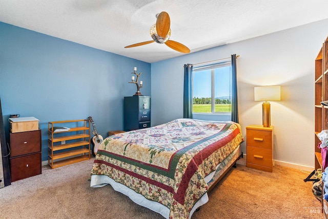 bedroom with ceiling fan and light colored carpet