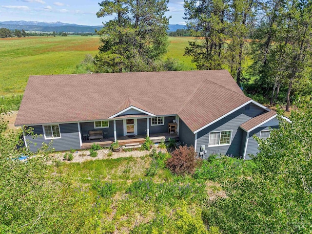 single story home with a front yard and a deck with mountain view