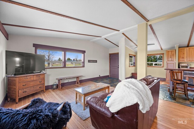 living room featuring light wood-style floors, plenty of natural light, and baseboards