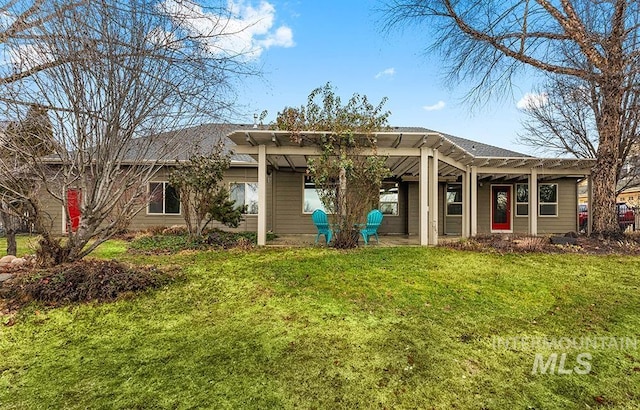 back of property with a yard and a pergola