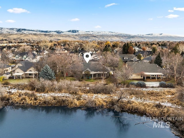 birds eye view of property featuring a water and mountain view