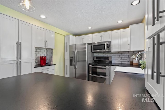 3001 S Roosevelt St Unit 9, Boise, ID 83705 - kitchen featuring stainless steel appliances, dark countertops, a textured ceiling, decorative backsplash, and recessed lighting
