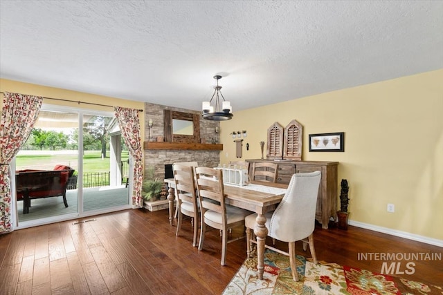 3001 S Roosevelt St Unit 9, Boise, ID 83705 - dining area featuring a chandelier, dark wood-style flooring, baseboards, and a textured ceiling