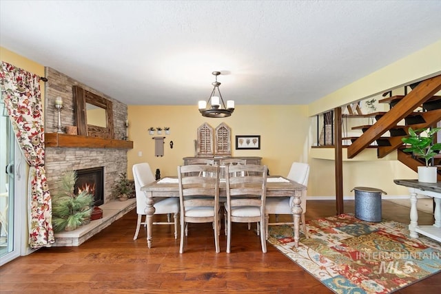 3001 S Roosevelt St Unit 9, Boise, ID 83705 - dining area with wood finished floors, a chandelier, and a fireplace