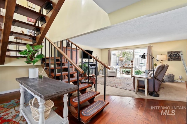 3001 S Roosevelt St Unit 9, Boise, ID 83705 - stairway with wood-type flooring, baseboards, and a textured ceiling