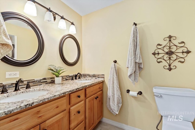 3001 S Roosevelt St Unit 9, Boise, ID 83705 - bathroom with toilet, double vanity, and baseboards