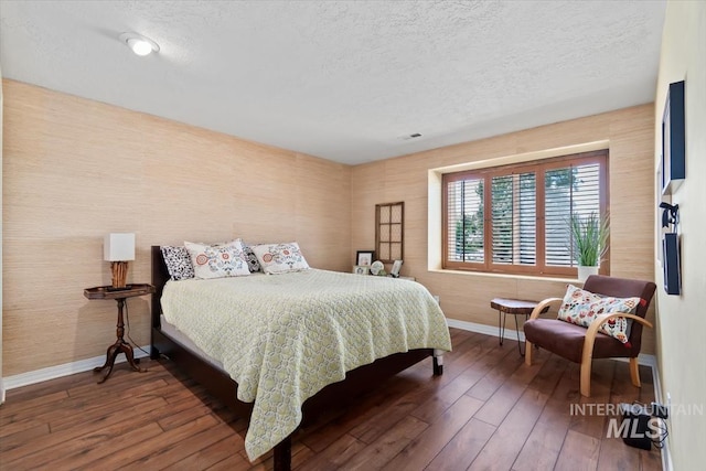 3001 S Roosevelt St Unit 9, Boise, ID 83705 - bedroom with baseboards, hardwood / wood-style floors, a textured ceiling, and wallpapered walls