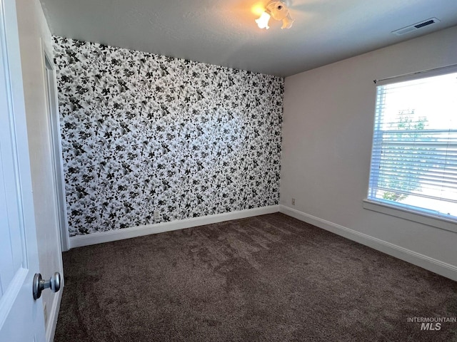 322 Linden Ave, Twin Falls, ID 83301 - empty room with dark colored carpet, wallpapered walls, and baseboards
