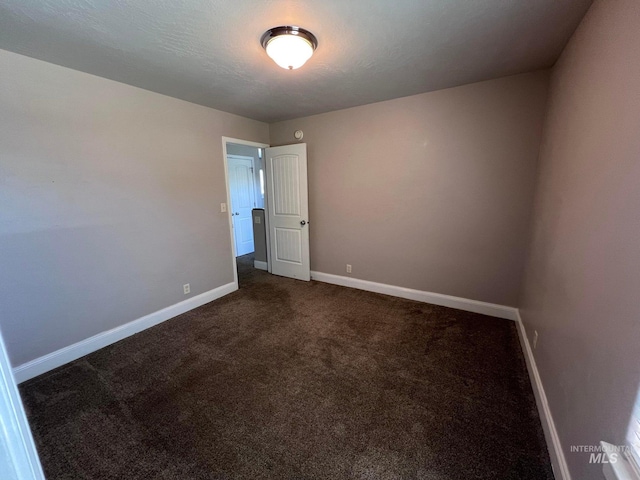 322 Linden Ave, Twin Falls, ID 83301 - empty room with baseboards and dark colored carpet
