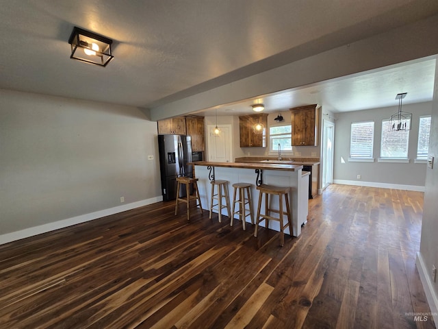 322 Linden Ave, Twin Falls, ID 83301 - kitchen featuring stainless steel fridge with ice dispenser, dark wood-style flooring, baseboards, and a sink