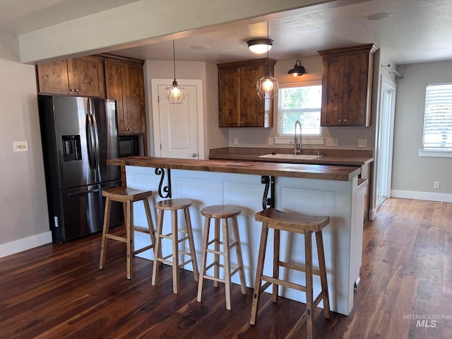 322 Linden Ave, Twin Falls, ID 83301 - kitchen with wooden counters, stainless steel fridge, a sink, dark wood finished floors, and baseboards
