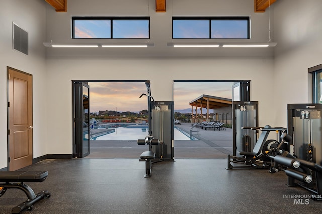 workout area with a towering ceiling