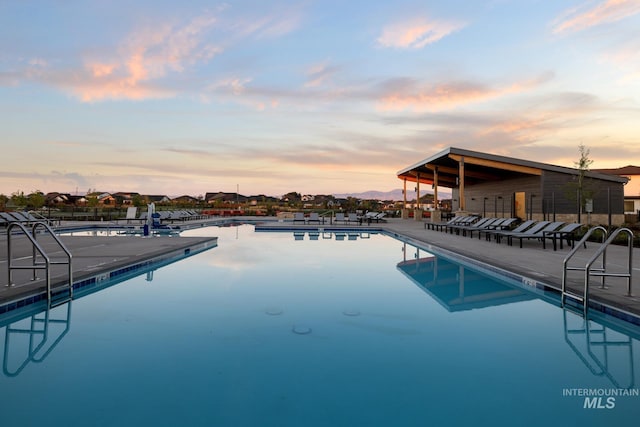 pool at dusk with a patio