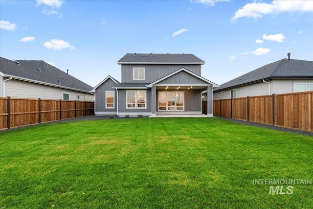 back of house featuring a yard