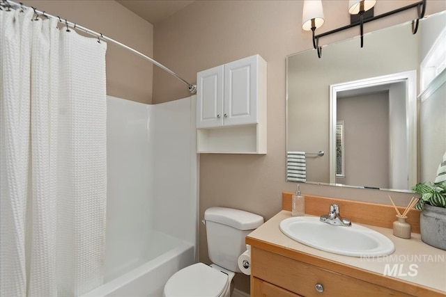 full bathroom with shower / bath combo with shower curtain, toilet, and vanity