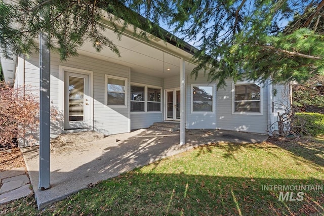 view of front of property featuring french doors, a front yard, and entry steps