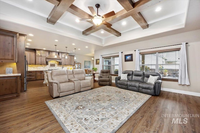 living room featuring beamed ceiling, ceiling fan, and dark wood-type flooring