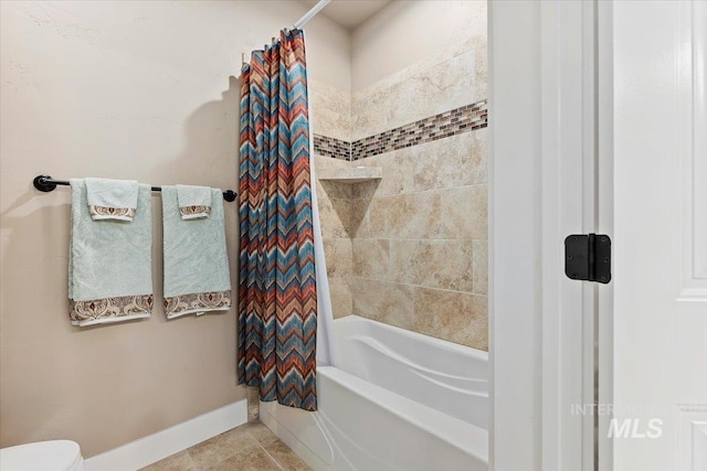 bathroom with tile patterned floors and shower / tub combo with curtain