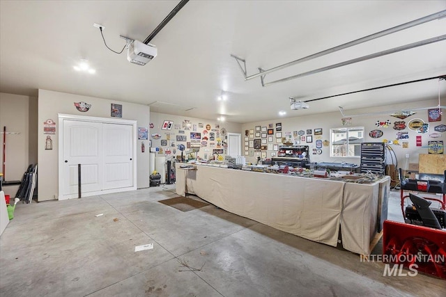 garage with a workshop area and a garage door opener