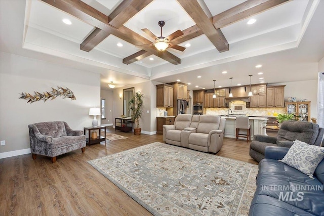 living room featuring wood-type flooring, ceiling fan, coffered ceiling, and beam ceiling