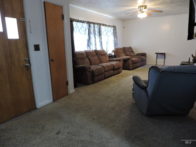 carpeted living room featuring ceiling fan