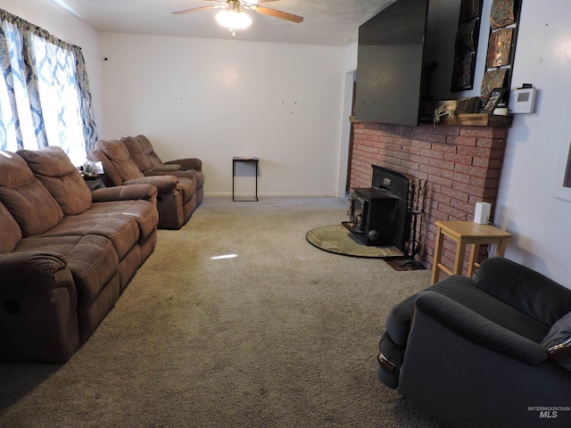 carpeted living room with a ceiling fan and baseboards