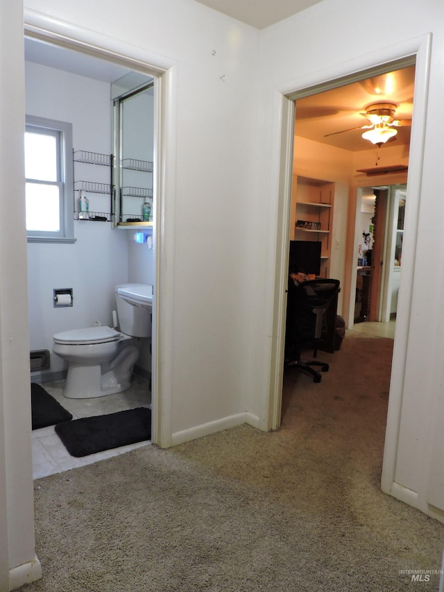 bathroom with built in features, baseboards, carpet flooring, and toilet