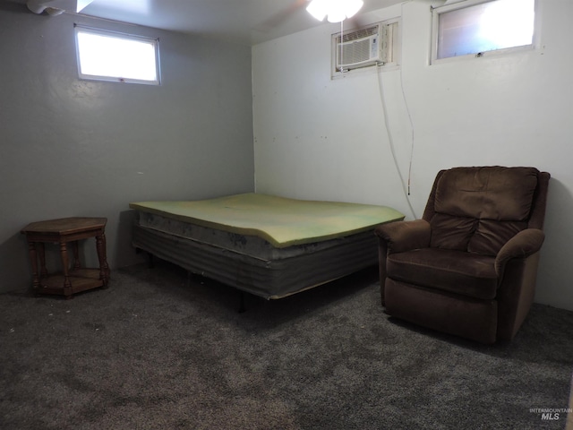 bedroom featuring an AC wall unit and carpet flooring