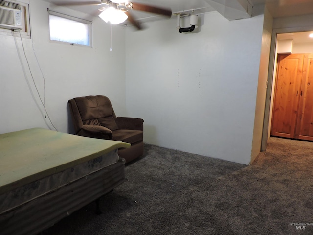 carpeted bedroom with ceiling fan and an AC wall unit