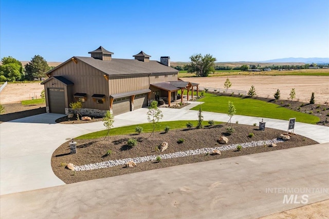 8860 Kemp Rd, Middleton, ID 83607 - view of side of home with board and batten siding, concrete driveway, and an attached garage