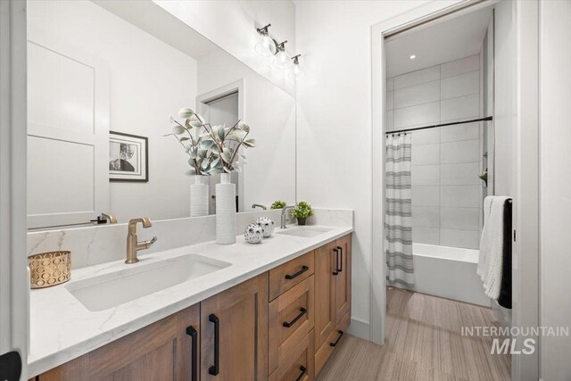 8860 Kemp Rd, Middleton, ID 83607 - bathroom featuring double vanity, shower / bathtub combination with curtain, and wood finished floors