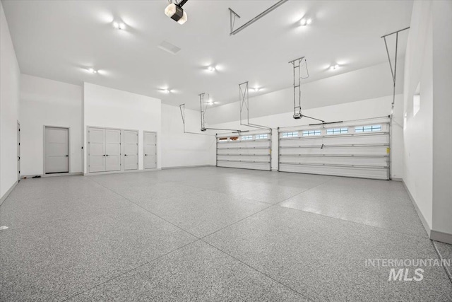 8860 Kemp Rd, Middleton, ID 83607 - garage with baseboards and a garage door opener