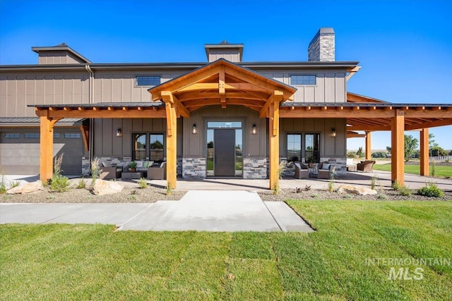 8860 Kemp Rd, Middleton, ID 83607 - rear view of property with outdoor lounge area, board and batten siding, a lawn, a chimney, and a patio